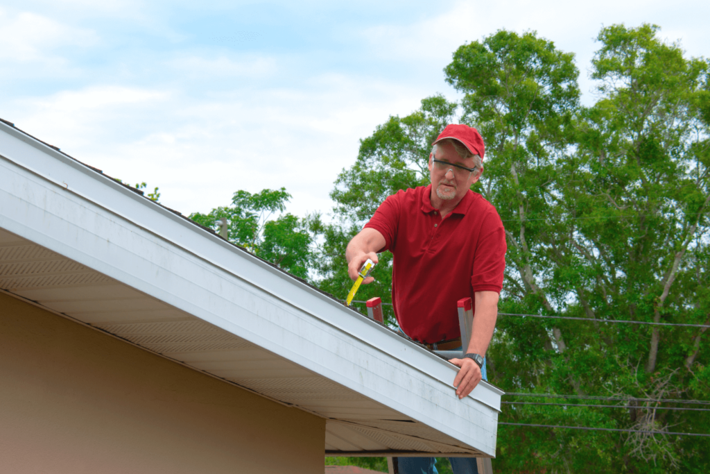 Homeowner inspecting the roof of his residential home