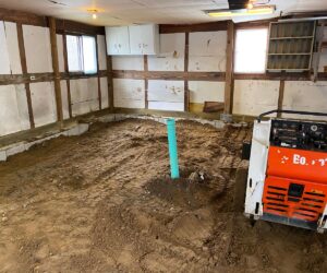 Excavation of old flooring during concrete floor installation process