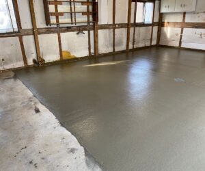 Concrete flooring freshly poured and smoothed in a garage