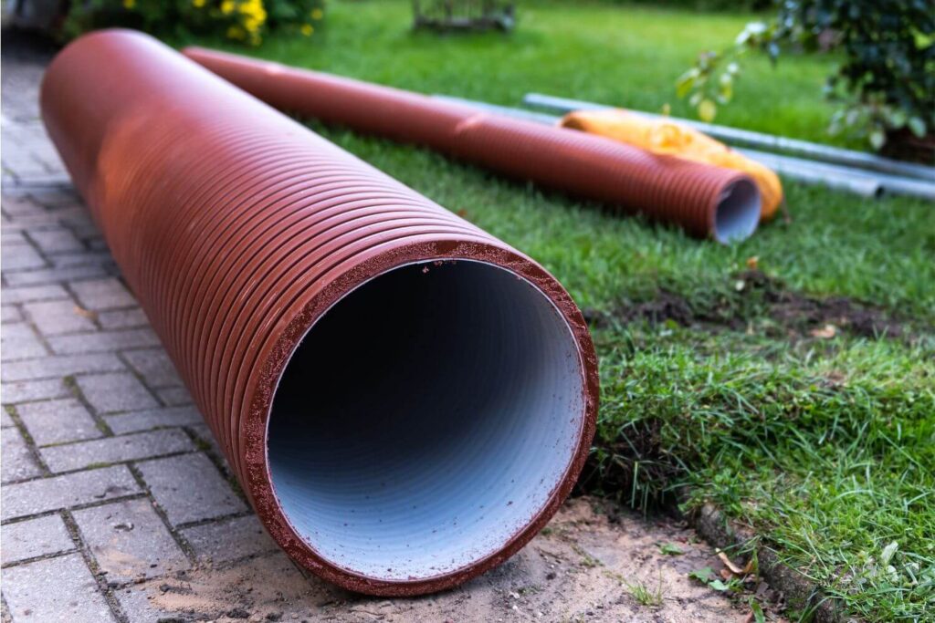 New sewer pipes placed in the yard of a residential home in preparation for sewer line replacement