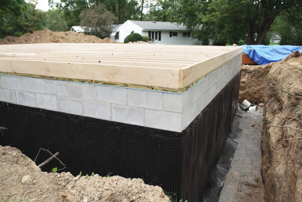 New construction basement foundation with a heavy duty waterproofing membrane installed