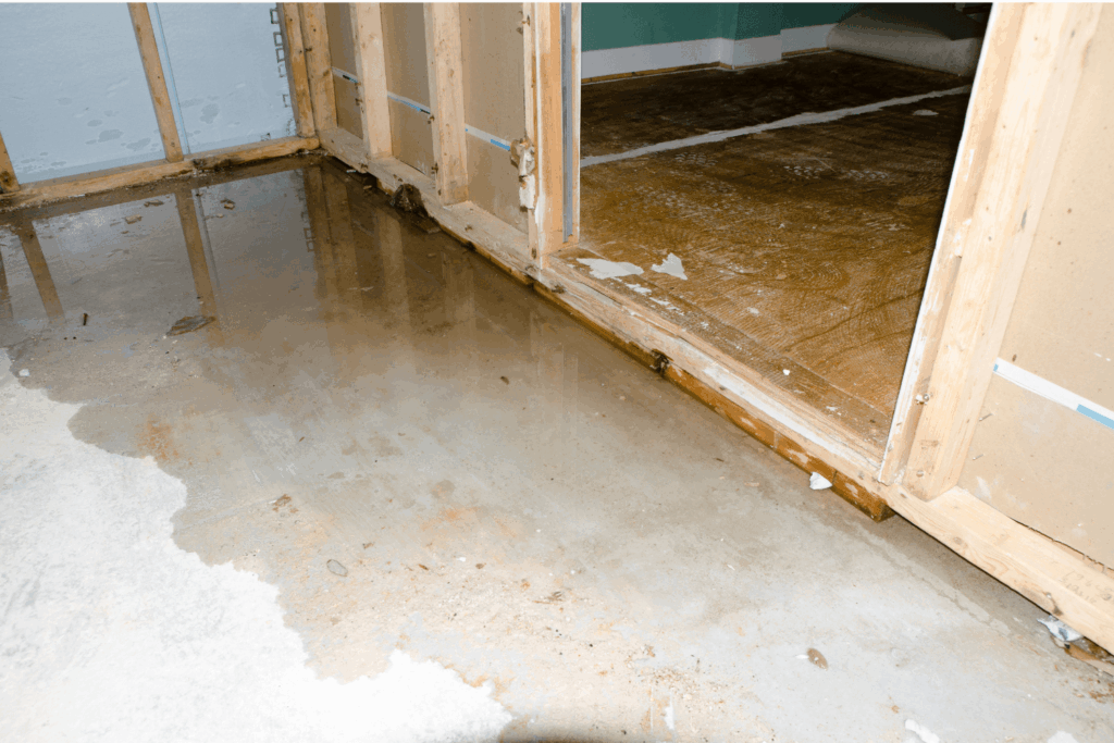 A basement with a wooden floor that has been damaged by water