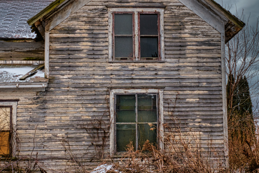 An old, worn-down home made of wood.