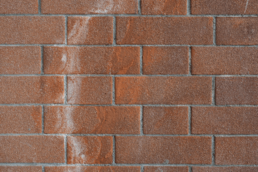 Signs of efflorescence on brick wall