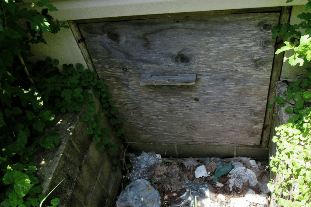 Older crawl space door showing gaps